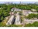 Aerial view of a modern townhome community with lush green surroundings and a cityscape backdrop at 1099 North Ne Ave # 12, Atlanta, GA 30307