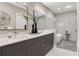 Elegant bathroom featuring double sinks, a sleek vanity, and a glass-enclosed shower and tub at 1099 North Ne Ave # 12, Atlanta, GA 30307
