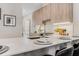 Charming kitchen with wood cabinets, quartz countertops, and barstool seating at 1099 North Ne Ave # 12, Atlanta, GA 30307