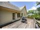 Wooden back deck off house includes gas grill with a partial view of a treed backyard at 629 Pine Ter, Canton, GA 30114