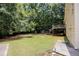 Large, green backyard with mature trees, storage shed, and a small deck off the house at 629 Pine Ter, Canton, GA 30114