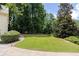 View of a well-manicured backyard with lush greenery and mature trees at 629 Pine Ter, Canton, GA 30114