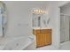 Bright bathroom with single sink, walk-in shower, and corner tub beneath a window for natural light at 629 Pine Ter, Canton, GA 30114