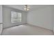 Bedroom with a ceiling fan, plush carpet, and a window that provides natural light at 629 Pine Ter, Canton, GA 30114