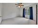 Bright bedroom with ceiling fan, plush carpeting, large window with a view, and blue curtains at 629 Pine Ter, Canton, GA 30114