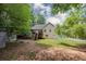 Charming home exterior featuring a two-story design with a wooden deck, lush greenery, and a private backyard at 629 Pine Ter, Canton, GA 30114