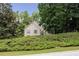 Front exterior view showcases curb appeal with lush greenery and mature trees surrounding the home at 629 Pine Ter, Canton, GA 30114