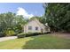 View of the front yard and home with lush green lawn and mature trees, showcasing its curb appeal at 629 Pine Ter, Canton, GA 30114