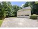Exterior of the home featuring a three-car garage and a spacious driveway at 629 Pine Ter, Canton, GA 30114