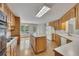 Eat-in kitchen area showing a center island, hardwood floors, wood cabinets, and modern lighting at 629 Pine Ter, Canton, GA 30114