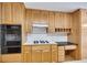 Kitchen showcases hardwood floors, wood cabinets, oven, and built-in desk area at 629 Pine Ter, Canton, GA 30114