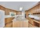 Kitchen boasting a center island, oak cabinetry, wood floors, and stainless steel appliances at 629 Pine Ter, Canton, GA 30114