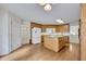 Kitchen features hardwood floors, center island, and a large doorway to the dining room at 629 Pine Ter, Canton, GA 30114
