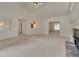 Bright living room featuring a ceiling fan, neutral carpeting, fireplace, and ample natural light at 629 Pine Ter, Canton, GA 30114