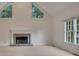 Spacious living room with stone fireplace, large windows, and ample natural light at 629 Pine Ter, Canton, GA 30114
