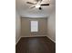 Bedroom features dark wood-look floors, ceiling fan, neutral walls, and window with blinds at 425 Orchard Dr, Stone Mountain, GA 30083