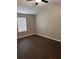 Bright bedroom features dark wood-look floors and a ceiling fan for comfortable living at 425 Orchard Dr, Stone Mountain, GA 30083