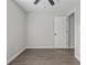 A bright bedroom features a ceiling fan and a door to the hallway at 425 Orchard Dr, Stone Mountain, GA 30083