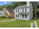 Charming two-story home with a welcoming front porch and well-manicured lawn in a peaceful neighborhood at 425 Orchard Dr, Stone Mountain, GA 30083