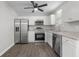 Modern kitchen with stainless steel appliances, granite countertops, white cabinetry, and laminate flooring at 425 Orchard Dr, Stone Mountain, GA 30083