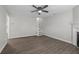 Open-concept living room with neutral paint, modern ceiling fan, and durable laminate flooring at 425 Orchard Dr, Stone Mountain, GA 30083