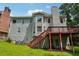 Backyard showcases a deck with stairs and a well-maintained lawn at 4467 Boatmans Cv, Stone Mountain, GA 30083