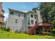 View of the exterior backyard with a deck and green grass at 4467 Boatmans Cv, Stone Mountain, GA 30083