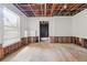 Unfinished basement with visible pipes, window, and a doorway to the toilet at 4467 Boatmans Cv, Stone Mountain, GA 30083