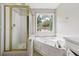 Bathroom includes a shower and a separate tub with a window at 4467 Boatmans Cv, Stone Mountain, GA 30083