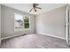 Bedroom with a ceiling fan and large windows offering pleasant outdoor views at 4467 Boatmans Cv, Stone Mountain, GA 30083