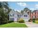 Two-story home with a well-manicured lawn, lush greenery, and attached garage at 4467 Boatmans Cv, Stone Mountain, GA 30083
