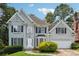 Charming two-story home with a well-manicured lawn, lush greenery, and attached garage at 4467 Boatmans Cv, Stone Mountain, GA 30083