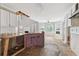 Kitchen with white cabinets, island, and stainless steel sink at 4467 Boatmans Cv, Stone Mountain, GA 30083