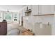 A view of the kitchen and breakfast nook with white cabinets and walls at 4467 Boatmans Cv, Stone Mountain, GA 30083