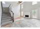 Spacious living room area with a fireplace, stairs and lots of natural light at 4467 Boatmans Cv, Stone Mountain, GA 30083