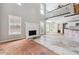 View of the living room, showcasing the open floor plan to the kitchen and staircase at 4467 Boatmans Cv, Stone Mountain, GA 30083