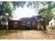 A brick home with a small backyard and mature trees at 1712 Clifton Se Way, Atlanta, GA 30316