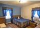 Bright bedroom with blue accents, hardwood floors, and an air conditioning unit at 1712 Clifton Se Way, Atlanta, GA 30316