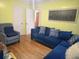 Cozy living room with a plush blue sofa, armchair, and wood floors at 1712 Clifton Se Way, Atlanta, GA 30316