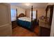 Comfortable main bedroom features a four-poster bed and vintage wood furniture at 1712 Clifton Se Way, Atlanta, GA 30316