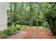 Beautiful backyard with lush landscaping leading to a stream surrounded by mature trees at 2200 Major Loring Sw Way, Marietta, GA 30064