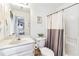 Bathroom featuring a white vanity, toilet, and shower with a gray curtain at 2200 Major Loring Sw Way, Marietta, GA 30064