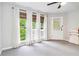 Bonus room featuring neutral walls, carpeted floors, modern ceiling fan, a doorway and large windows at 2200 Major Loring Sw Way, Marietta, GA 30064