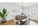 Elegant dining room featuring hardwood floors, plantation shutters, and a stylish chandelier at 2200 Major Loring Sw Way, Marietta, GA 30064