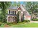 Beautiful two-story home with a well-kept lawn and mature trees providing a serene backdrop at 2200 Major Loring Sw Way, Marietta, GA 30064