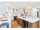 Bright, modern kitchen boasts white cabinets, stainless steel appliances, and a large island with seating and beverage refrigerator at 2200 Major Loring Sw Way, Marietta, GA 30064