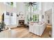 Airy living room with a fireplace, tall windows, hardwood floors, and a cozy sectional sofa at 2200 Major Loring Sw Way, Marietta, GA 30064