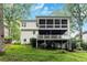 The rear exterior reveals a multi-level deck and screened porch, surrounded by lush greenery at 2200 Major Loring Sw Way, Marietta, GA 30064