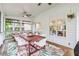 Inviting screened porch featuring a dining table, stylish seating, and an open pass-through to the kitchen at 2200 Major Loring Sw Way, Marietta, GA 30064
