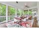 Charming screened porch with a dining table and chairs and comfortable seating, perfect for enjoying the outdoors at 2200 Major Loring Sw Way, Marietta, GA 30064